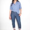 Girl in a button down modeling jeans