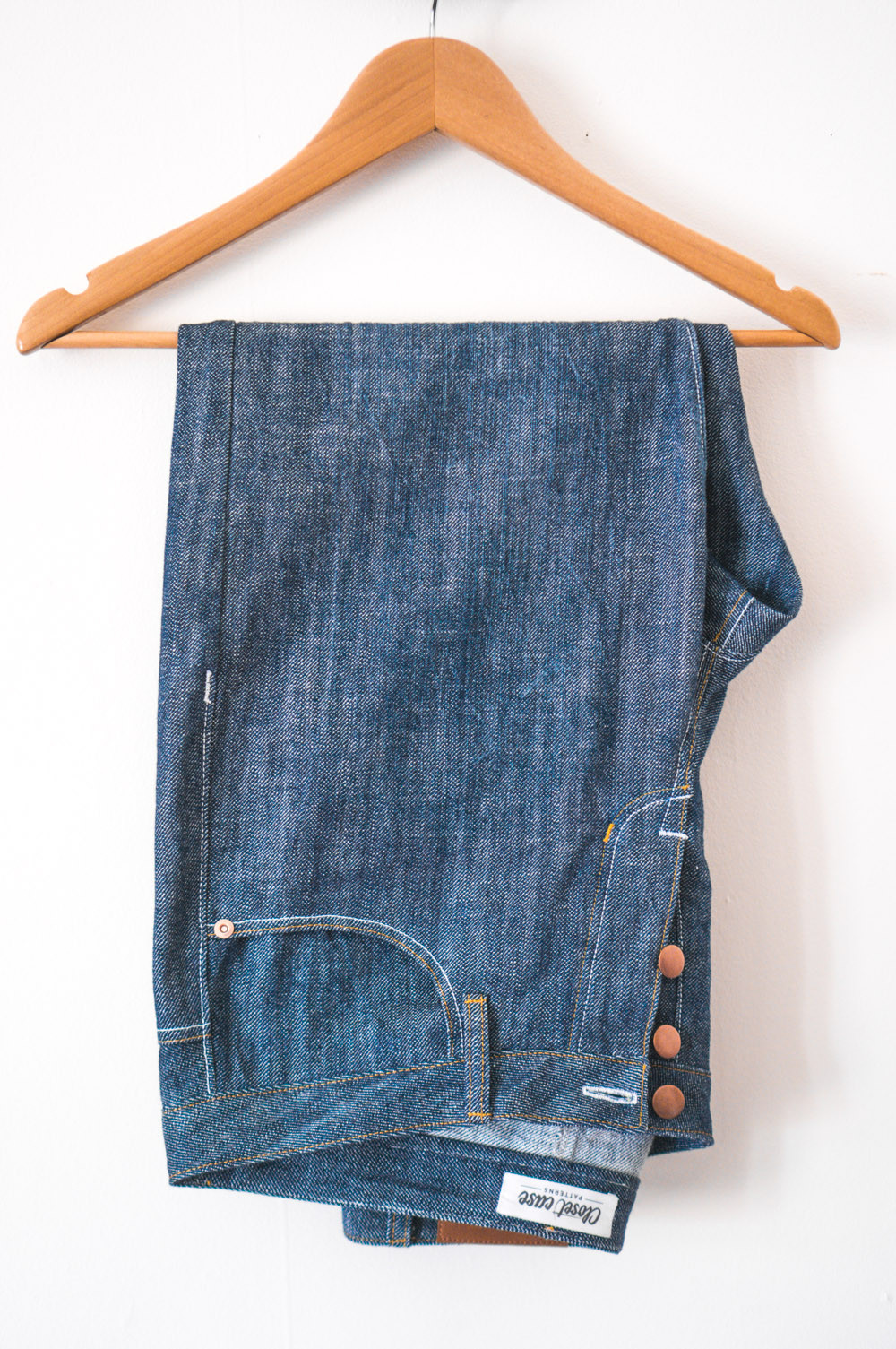 Jeans folded over a hanger