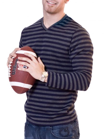 Man holding a football wearing a striped shirt
