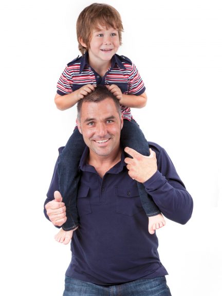 Man with a boy on his shoulders wearing polo shirts