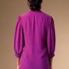 Back of a woman wearing a purple shirt