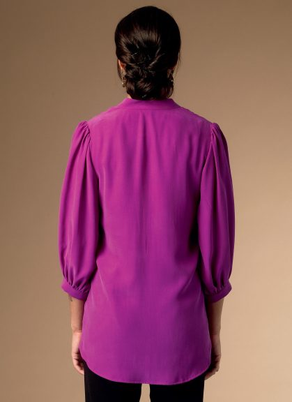 Back of a woman wearing a purple shirt