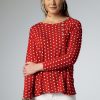Woman modeling a red and white polka dot top