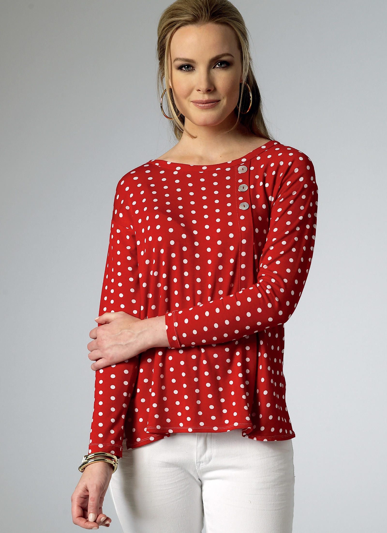 Woman modeling a red and white polka dot top