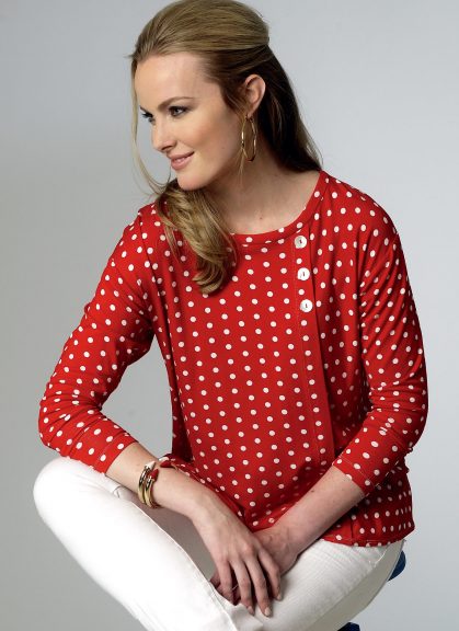 Woman modeling a red and white seam detail top