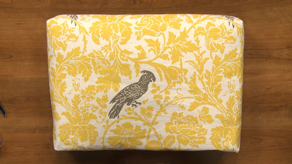 Yellow fabric pouch with a bird
