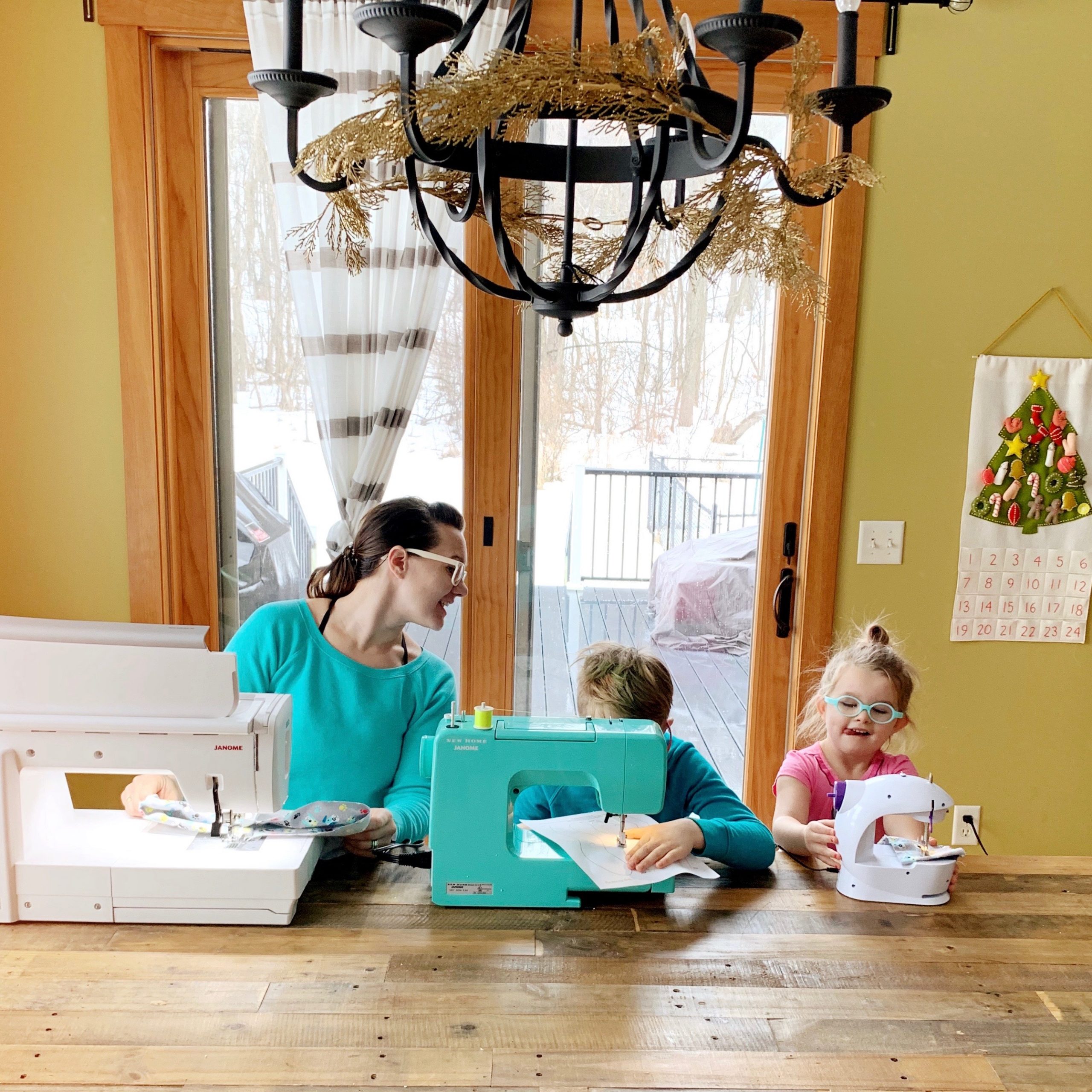 Woman and two kids with sewing machines