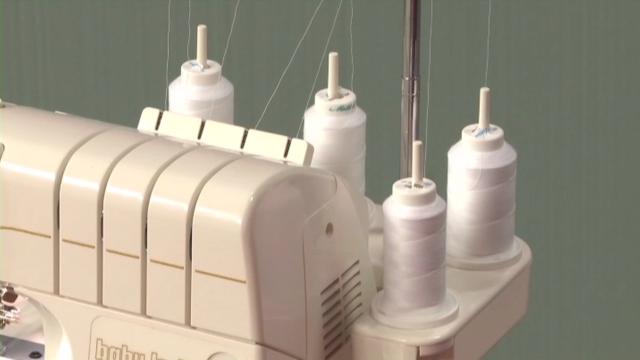 Serger with rolls of white thread