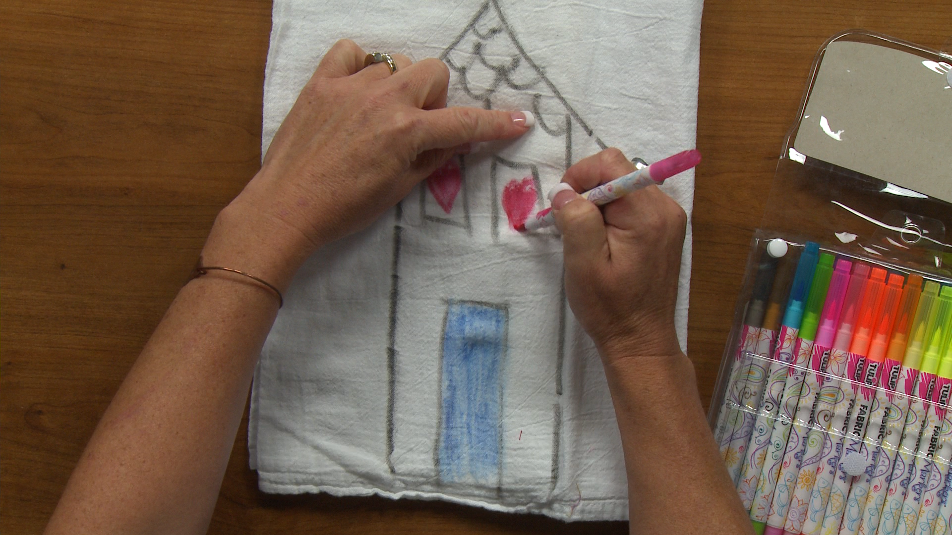 Drawing a house with fabric markers