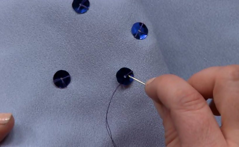 Sewing on blue sequins