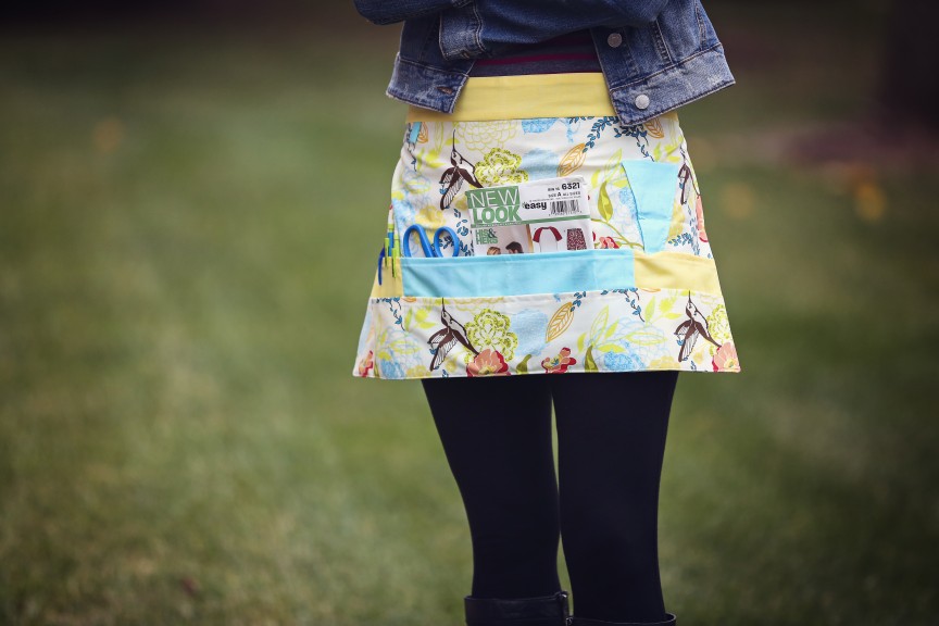 Person standing outside wearing a craft apron