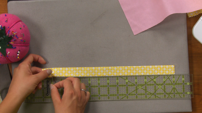 Sewing a long strip of yellow fabric