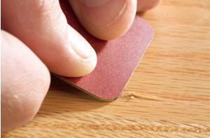 Once the fibers of the wood were dry, I used a small piece of plastic laminate (a credit card would work perfectly) to force the fibers back into place (Photo 4).