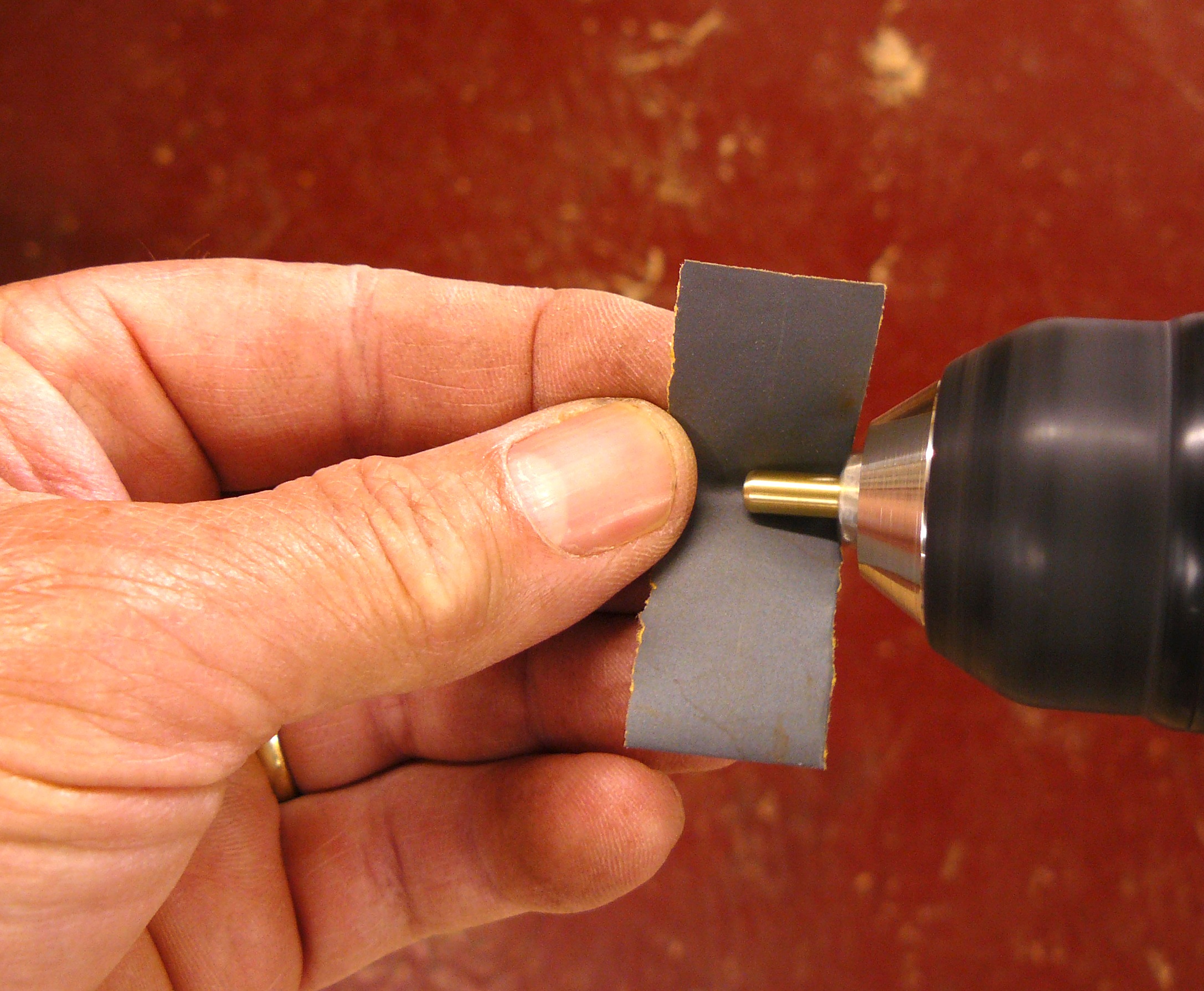 polishing a pin with grit paper