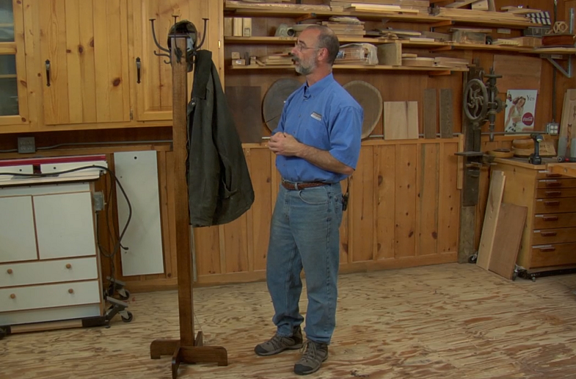 Man with a wooden coat rack