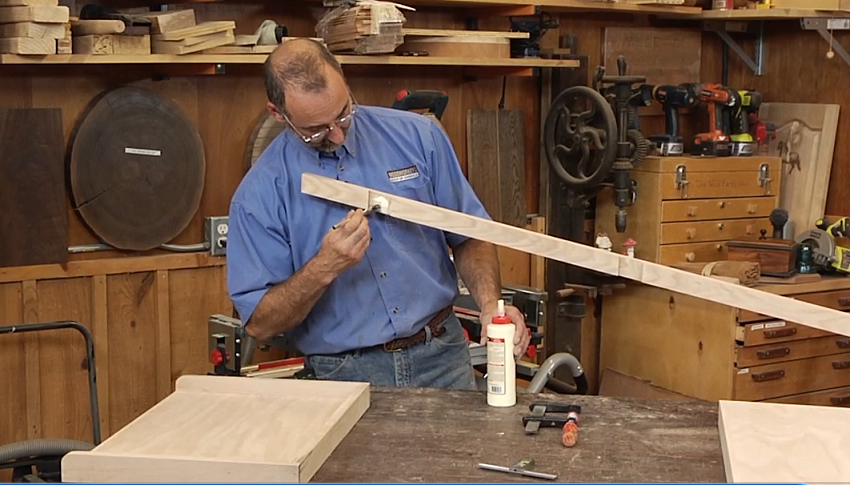 Adding glue to a wood piece