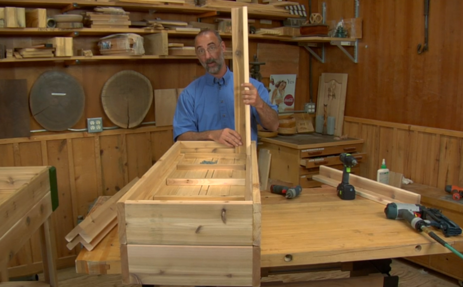 Man building a wooden planter