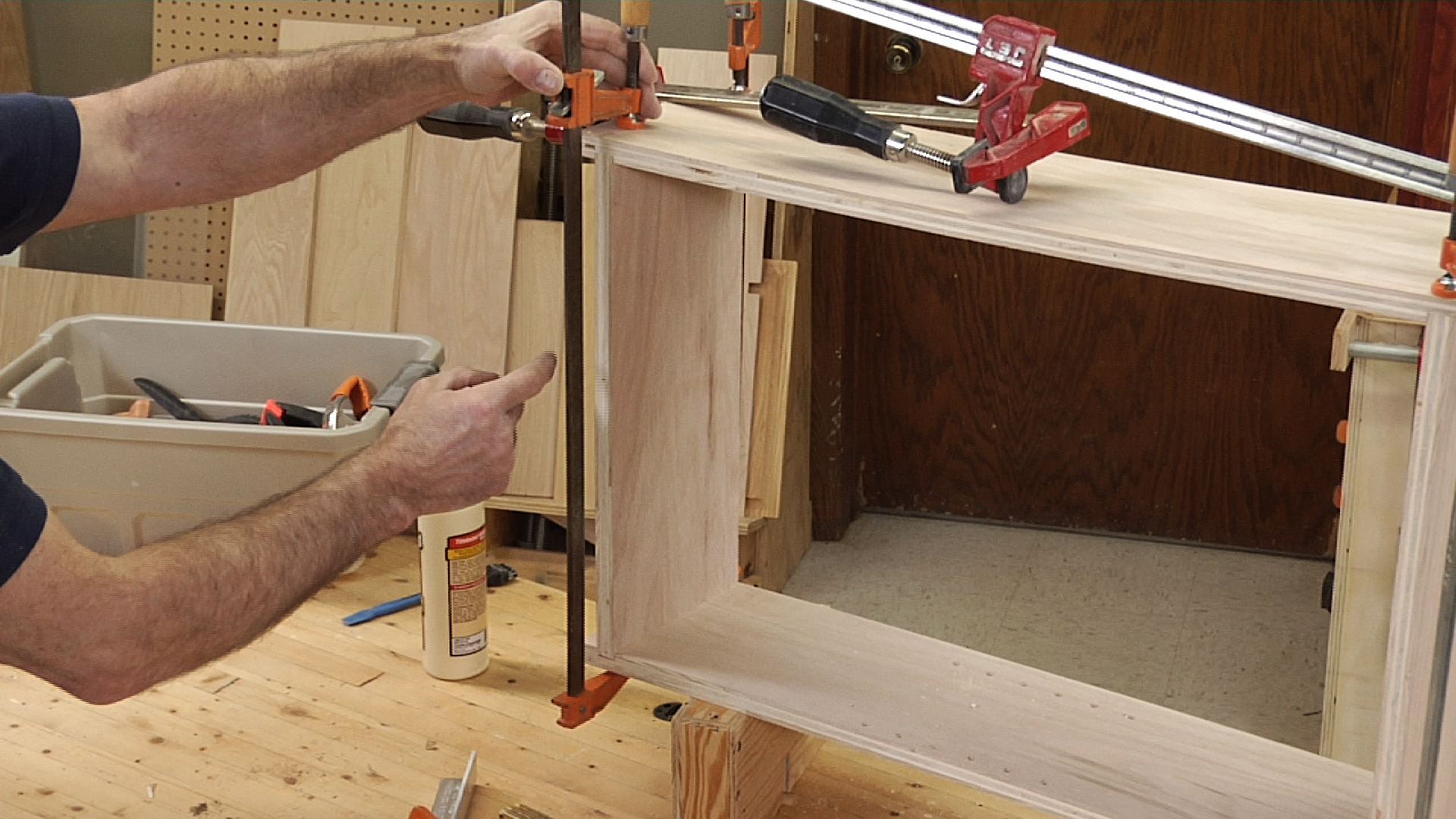 using a clamp to assemble a cabinet