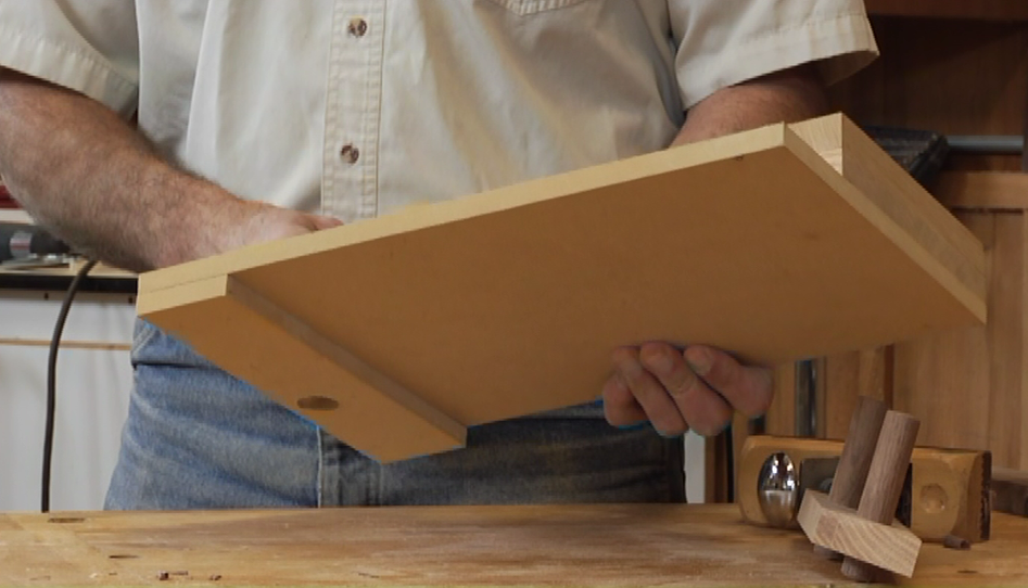 Person holding a wooden board