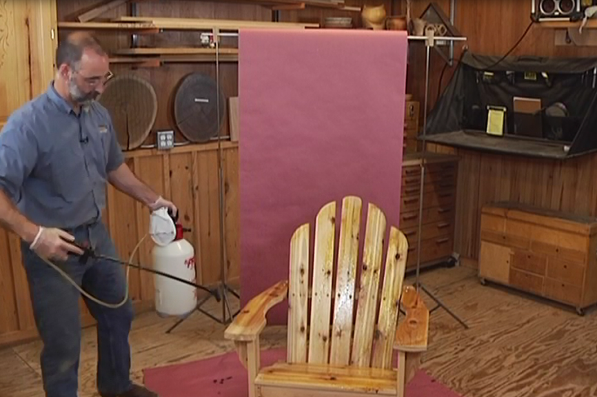 Spraying an Adirondack chair