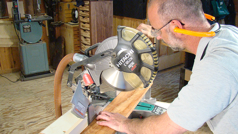 man using a miter saw