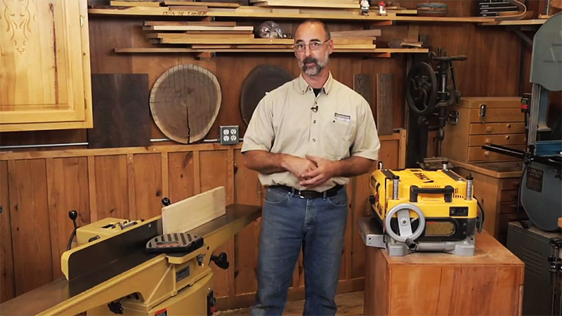 man standing with a jointer and a planer