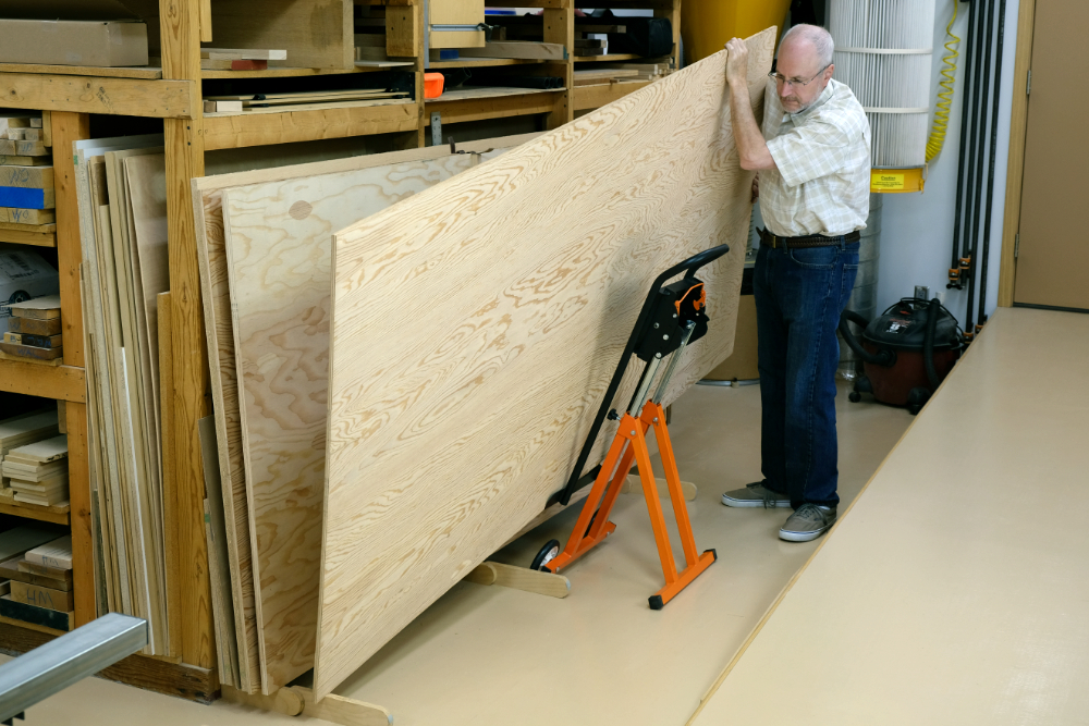 man with a large plank of wood