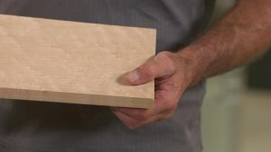 Person holding a piece of wood