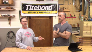 Two men talking in a workshop