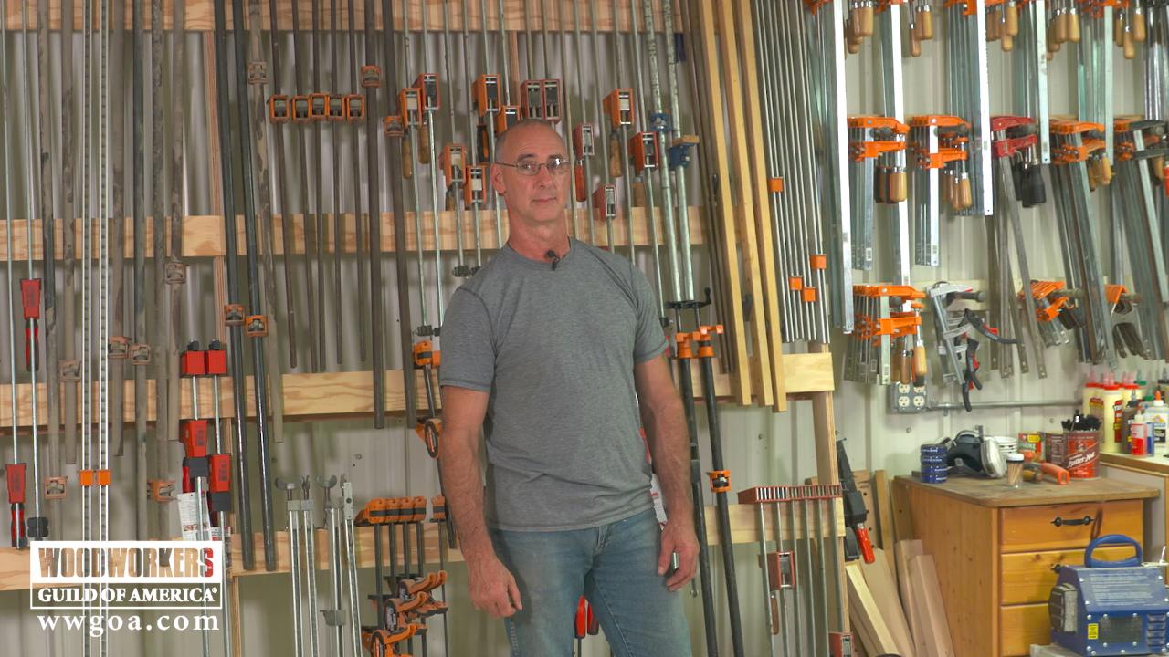 man standing in front of organized clamps