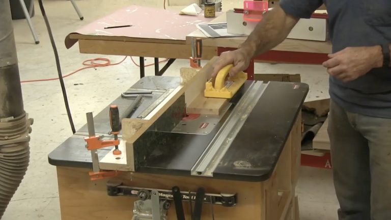Man doing edge jointing on a router table