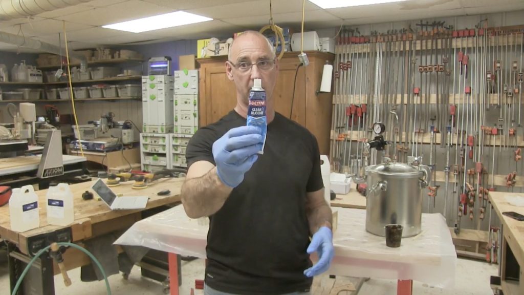 Man holding a tube of apoxy