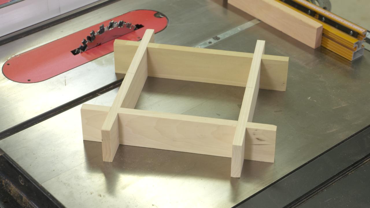 Four wooden pieces making a square