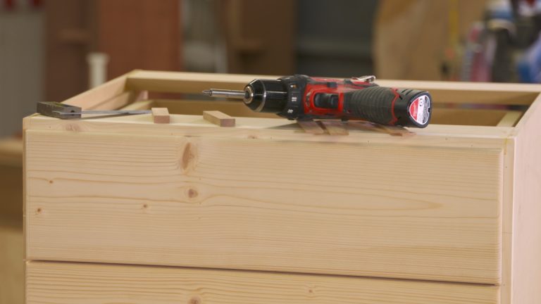 Screw driver on a wooden box