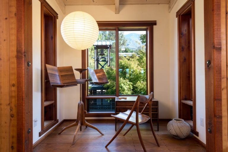 Wooden chair and stand by a large window