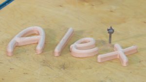 Small wooden letters spelling Alex