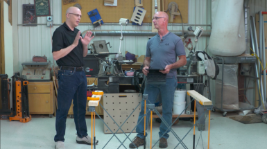 Two men talking in a workshop
