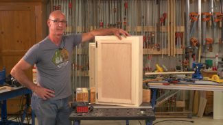 Man with a wooden cabinet