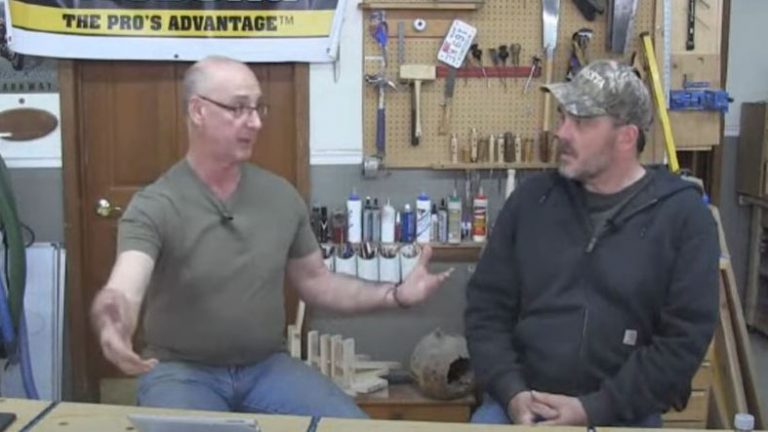 Two men talking in a wood workshop