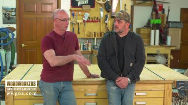 Two men talking in a wood shop