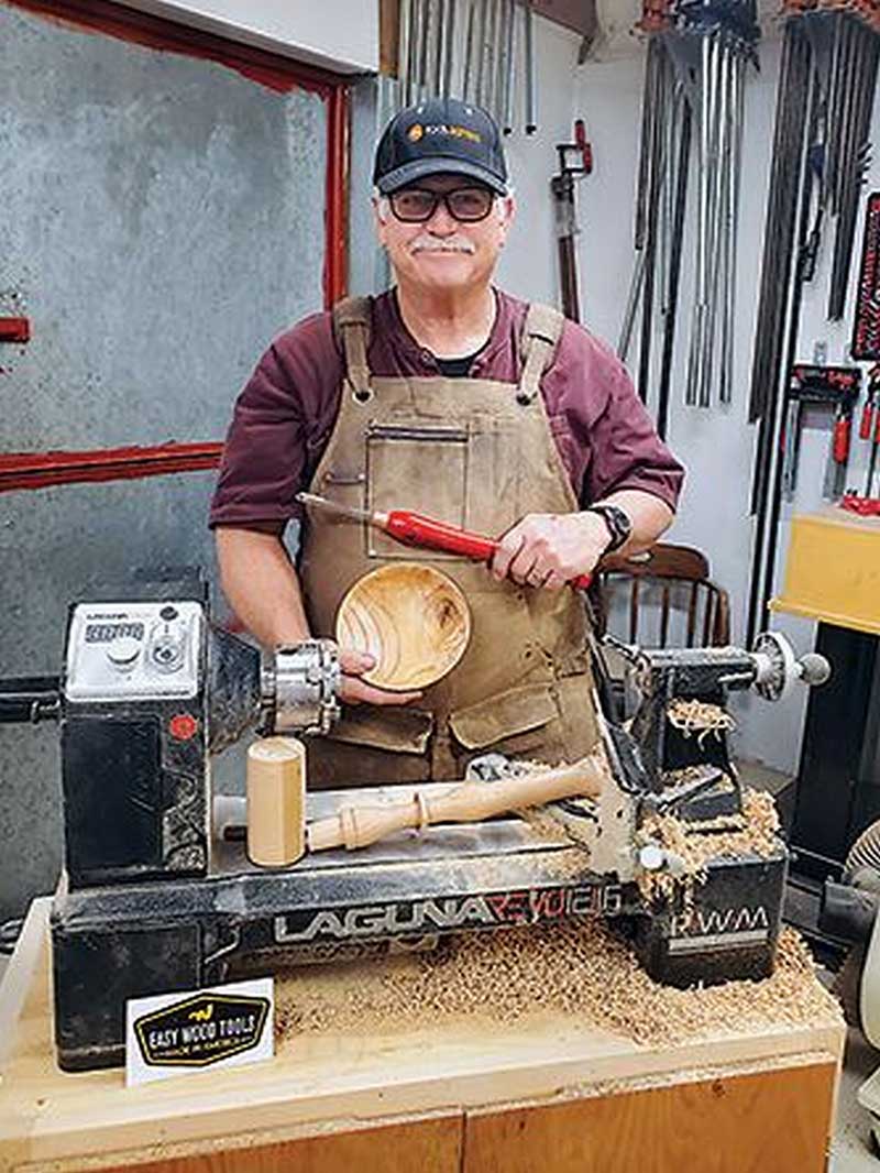 man holding a wood turned bowl