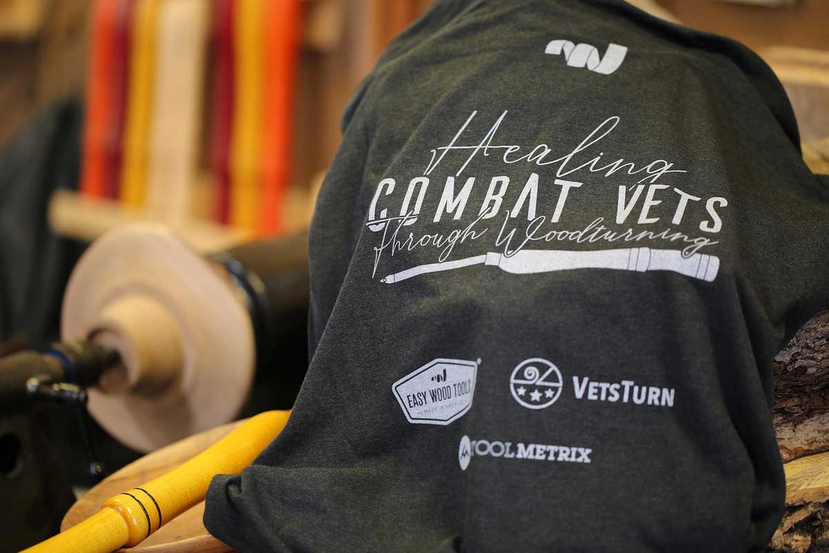 Shirt with logos and text about healing combat vets through woodturning