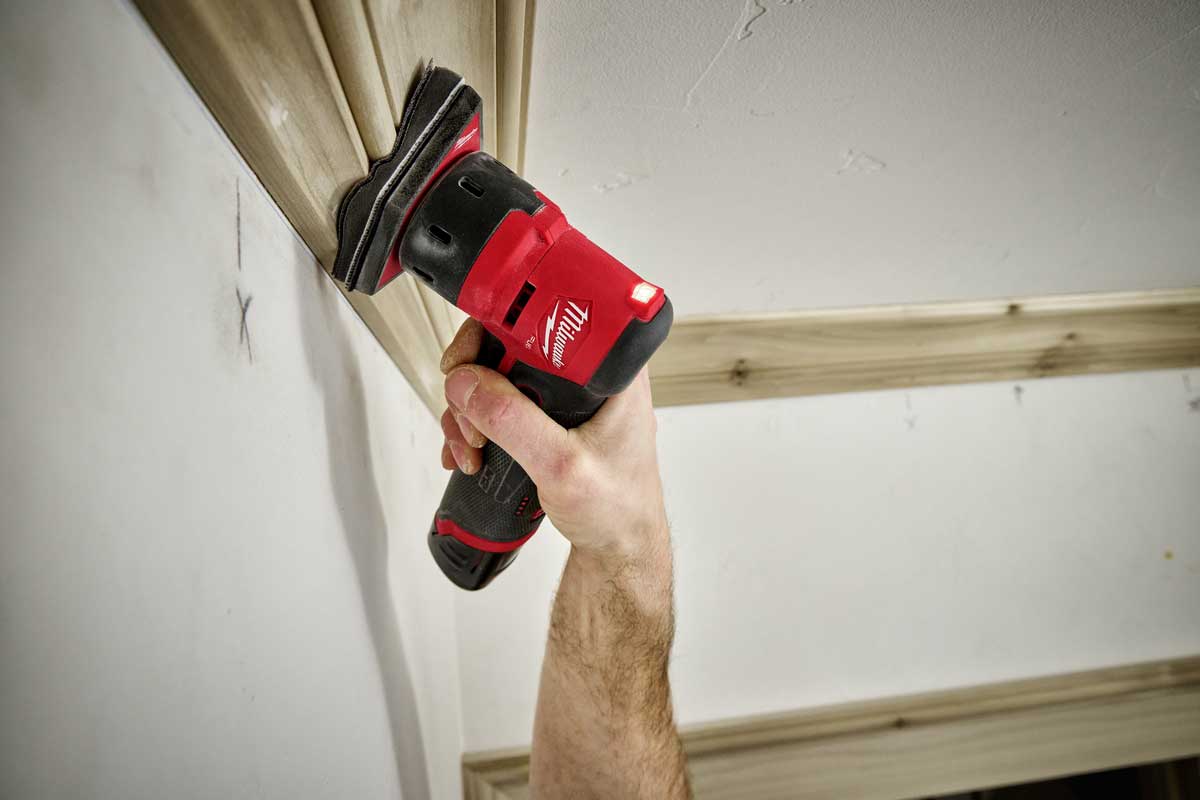 person using a sander with a sponge interface