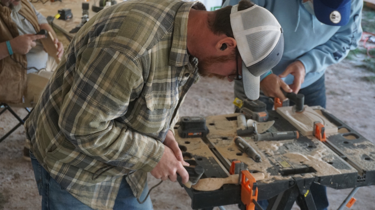men using a woodworking tool for spoon carving