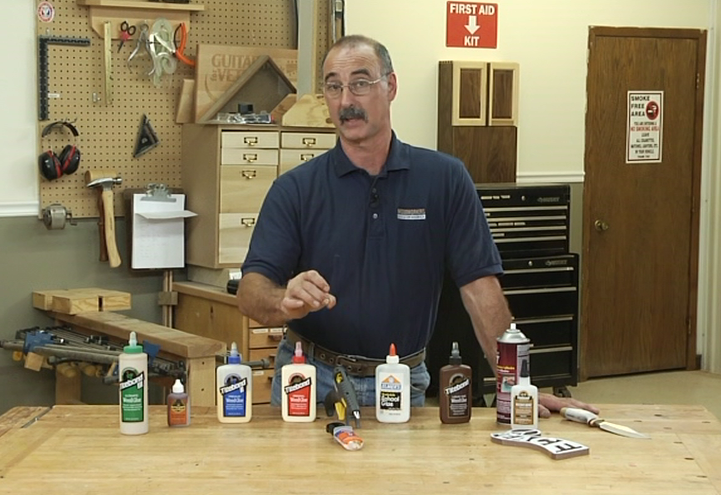 Man with a variety of glue bottles