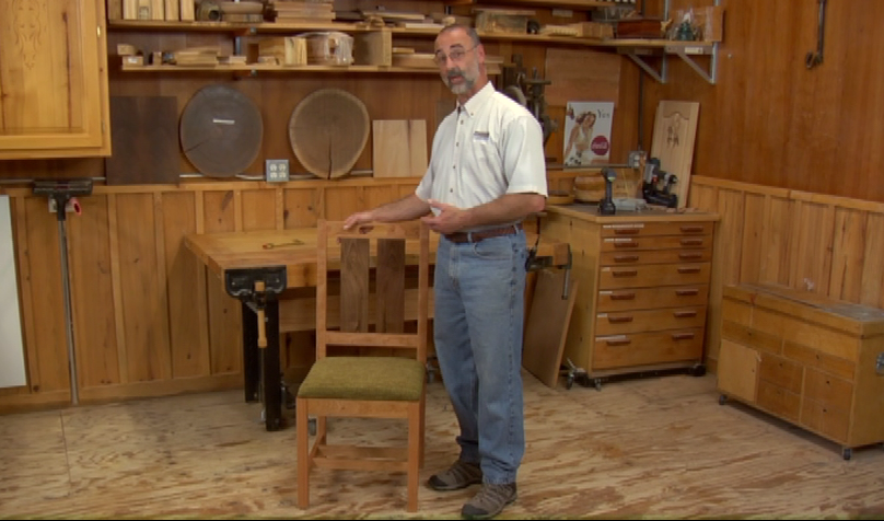 Man with a wooden chair